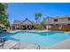 Community pool with lounge chairs and shaded seating area at 3249 Dayflower St # C, Las Vegas, NV 89121