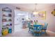 Bright dining area adjacent to the kitchen, featuring a stylish table and chairs set and open shelving at 3249 Dayflower St # C, Las Vegas, NV 89121