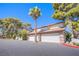 Spacious townhome featuring multiple garage doors and mature trees in a well-maintained neighborhood at 3249 Dayflower St # C, Las Vegas, NV 89121