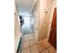 Inviting hallway featuring neutral tile flooring and view into the sunlit living room at 3249 Dayflower St # C, Las Vegas, NV 89121
