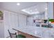 Modern kitchen with skylight, breakfast bar and white cabinetry providing ample storage space at 3249 Dayflower St # C, Las Vegas, NV 89121