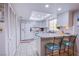 Bright kitchen featuring white cabinetry, skylight, a breakfast bar and modern appliances at 3249 Dayflower St # C, Las Vegas, NV 89121