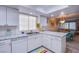 Well-lit kitchen featuring a skylight, white cabinetry, a breakfast bar and stainless steel appliances at 3249 Dayflower St # C, Las Vegas, NV 89121