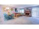 Bright living room with a brick fireplace, adjacent dining area, and sliding glass doors at 3249 Dayflower St # C, Las Vegas, NV 89121