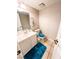 Bright powder room with modern vanity, neutral tile floor, and decorative blue rug at 3249 Dayflower St # C, Las Vegas, NV 89121