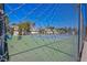 Community tennis court enclosed by chain link fence, showcasing a recreational amenity at 3249 Dayflower St # C, Las Vegas, NV 89121