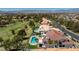 Aerial shot of home featuring tile roof, pool, golf course, and distant mountains at 35 Ventana Canyon Dr, Las Vegas, NV 89113