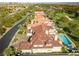 Captivating aerial perspective of a luxury estate with a sprawling tile roof, backyard pool, and meticulously landscaped grounds at 35 Ventana Canyon Dr, Las Vegas, NV 89113