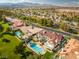 Sweeping aerial view of a luxurious home featuring a sparkling pool and lush green lawn at 35 Ventana Canyon Dr, Las Vegas, NV 89113