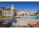Stunning backyard featuring a pool, spa, stone patio, and lush landscaping, ideal for outdoor enjoyment and relaxation at 35 Ventana Canyon Dr, Las Vegas, NV 89113