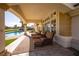 Relaxing backyard patio with comfortable lounge chairs that overlook a swimming pool and beautifully landscaped surroundings at 35 Ventana Canyon Dr, Las Vegas, NV 89113
