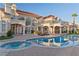Expansive backyard with a sparkling pool, lush landscaping, and multiple seating areas for outdoor enjoyment at 35 Ventana Canyon Dr, Las Vegas, NV 89113