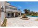 Spacious backyard with stone patio, a beautiful fountain, and a view of the inviting pool area at 35 Ventana Canyon Dr, Las Vegas, NV 89113