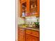 Wet bar area with wooden cabinets and granite countertops at 35 Ventana Canyon Dr, Las Vegas, NV 89113