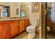 Modern bathroom features granite counters, wood cabinetry, and glass enclosed shower at 35 Ventana Canyon Dr, Las Vegas, NV 89113