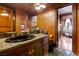 A granite countertop, dark-wood cabinetry and plenty of storage are the highlights of this lovely bathroom at 35 Ventana Canyon Dr, Las Vegas, NV 89113