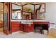 Well appointed bathroom with marble countertops, custom cabinets, decorative sink, and unique jellyfish art piece at 35 Ventana Canyon Dr, Las Vegas, NV 89113