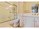 Bright bathroom featuring white vanity, tile shower, and gold accents at 35 Ventana Canyon Dr, Las Vegas, NV 89113