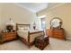 Cozy bedroom boasts natural light, decorative lighting, carpeted floors, and soft, neutral tones at 35 Ventana Canyon Dr, Las Vegas, NV 89113