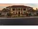 Elegant home exterior featuring manicured landscaping, a grand entrance, and soft evening lighting at 35 Ventana Canyon Dr, Las Vegas, NV 89113