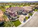Aerial view of a white home with a large yard and lush landscaping at 35 Ventana Canyon Dr, Las Vegas, NV 89113