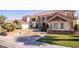 Beautiful home featuring lush landscaping, a circular driveway, and an elegant exterior at 35 Ventana Canyon Dr, Las Vegas, NV 89113