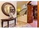 Inviting foyer featuring a decorative mirror, tiger sculpture and staircase leading to the upper level at 35 Ventana Canyon Dr, Las Vegas, NV 89113