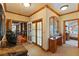 This foyer features an arched window, french doors, and a view of the Primary bedroom beyond at 35 Ventana Canyon Dr, Las Vegas, NV 89113