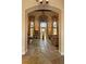 Grand living room featuring high ceilings, a decorative chandelier, and stone floors at 35 Ventana Canyon Dr, Las Vegas, NV 89113