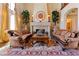 Cozy living room highlighting a stone fireplace, natural lighting and refined furniture at 35 Ventana Canyon Dr, Las Vegas, NV 89113
