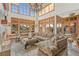 Bright living room with large windows, stone floors, and a fireplace at 35 Ventana Canyon Dr, Las Vegas, NV 89113