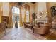 Elegant living room with a fireplace, floor to ceiling windows, and ornate furniture at 35 Ventana Canyon Dr, Las Vegas, NV 89113