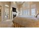 Bright main bedroom with vaulted ceilings, plantation shutters, fireplace, and access to a private patio at 35 Ventana Canyon Dr, Las Vegas, NV 89113