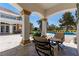 Charming patio area with comfortable seating, overlooking a sparkling pool and lush landscaped grounds at 35 Ventana Canyon Dr, Las Vegas, NV 89113