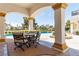 Covered patio with comfortable seating provides a relaxing outdoor experience overlooking a sparkling pool at 35 Ventana Canyon Dr, Las Vegas, NV 89113