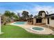 Enjoy a backyard oasis with a built in pool, spa, and covered outdoor kitchen at 3575 W Robindale Rd, Las Vegas, NV 89139