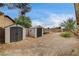 Two storage sheds in gravel backyard with block wall, offering plenty of space at 3575 W Robindale Rd, Las Vegas, NV 89139