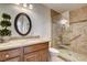 Bathroom showcases granite counters, dark wood cabinets, and a tiled walk-in shower with seat at 3575 W Robindale Rd, Las Vegas, NV 89139