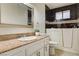 Bathroom vanity with granite counters and a walk-in bathtub at 3575 W Robindale Rd, Las Vegas, NV 89139