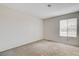 A vacant bedroom features carpet, neutral paint, and a window providing ample natural light at 3575 W Robindale Rd, Las Vegas, NV 89139