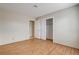 Bright bedroom featuring laminate flooring and a closet with white bi-fold doors at 3575 W Robindale Rd, Las Vegas, NV 89139
