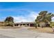 Traditional single story home with desert landscaping and brick driveway at 3575 W Robindale Rd, Las Vegas, NV 89139