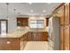 A well lit open kitchen featuring granite countertops, stainless steel appliances, and tile flooring at 3575 W Robindale Rd, Las Vegas, NV 89139