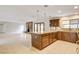 Open kitchen with granite countertops, stainless steel appliances, tile floors and fireplace at 3575 W Robindale Rd, Las Vegas, NV 89139