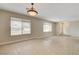 Large living room with bright, natural light, large windows and tile flooring at 3575 W Robindale Rd, Las Vegas, NV 89139