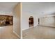 An open-concept layout connects the living room with stone fireplace to the kitchen through archways at 3575 W Robindale Rd, Las Vegas, NV 89139