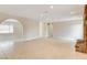 Bright, open living room with a stone fireplace, tile floors, and neutral colored walls at 3575 W Robindale Rd, Las Vegas, NV 89139
