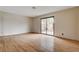 A bright living room with wood laminate floors and sliding glass doors leading to the backyard at 3575 W Robindale Rd, Las Vegas, NV 89139