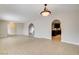 Open concept living room with arched doorway to kitchen and tile floors at 3575 W Robindale Rd, Las Vegas, NV 89139