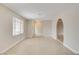 A bright living room with tile flooring, large window and neutral paint create an inviting space at 3575 W Robindale Rd, Las Vegas, NV 89139